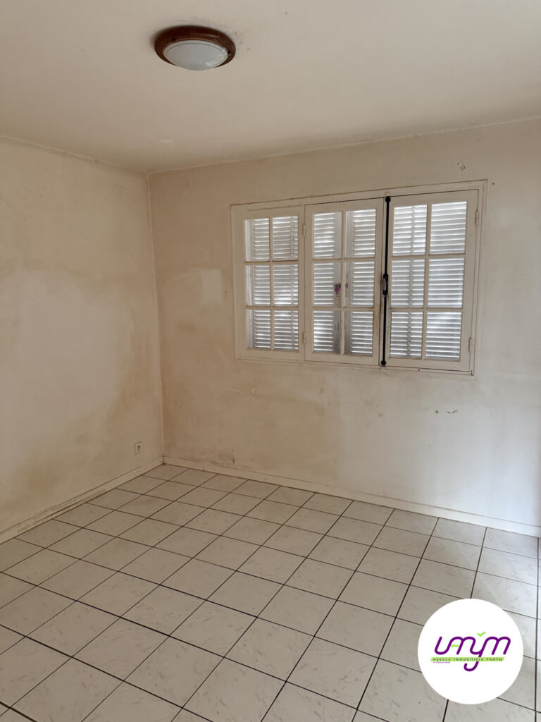 Chambre carrelée avec fenêtre à persiennes, maison F4 à vendre à Koutio par l’agence Vanym